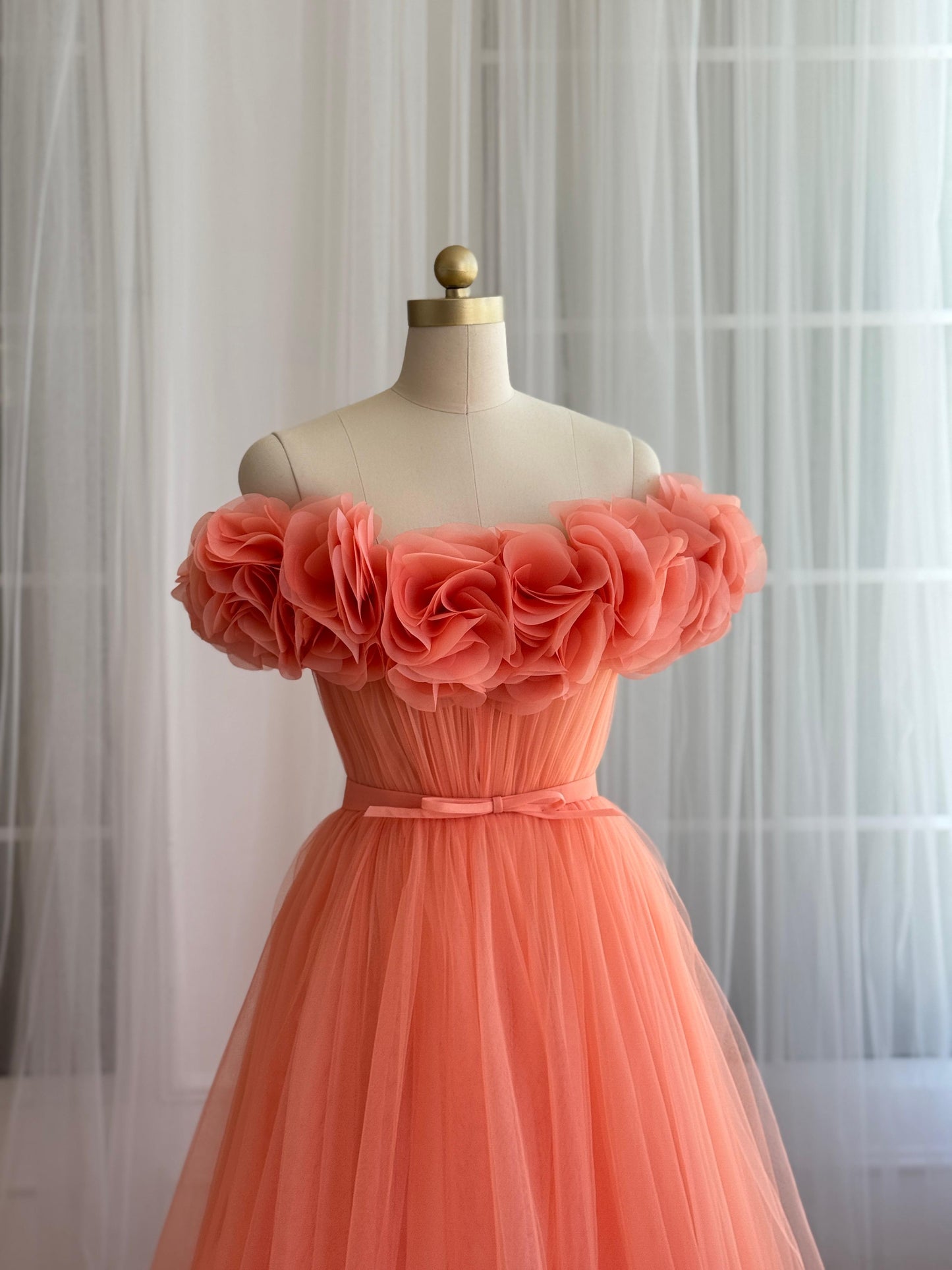 Peach A-Line gown with off the shoulder sleeves and embroidered flowers