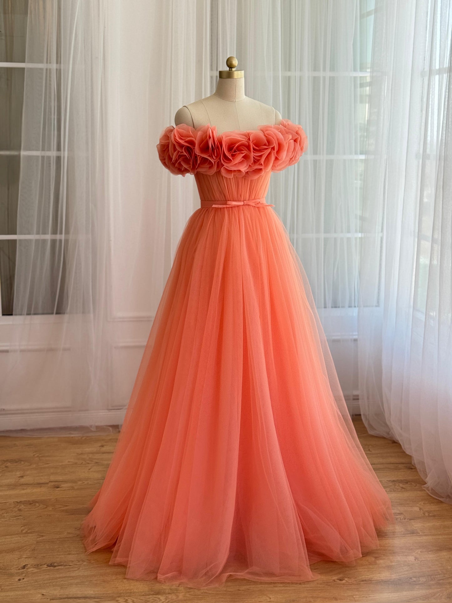Peach A-Line gown with off the shoulder sleeves and embroidered flowers
