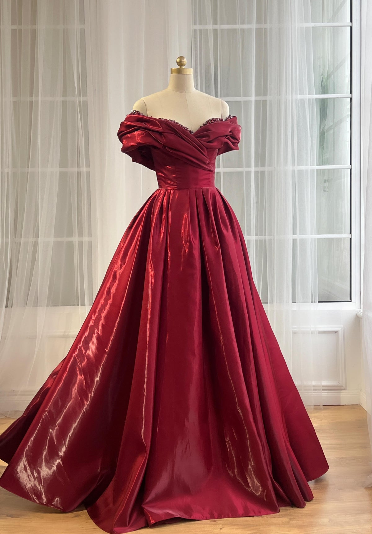 Red A-Line gown with off the shoulder sleeves and embroidery
