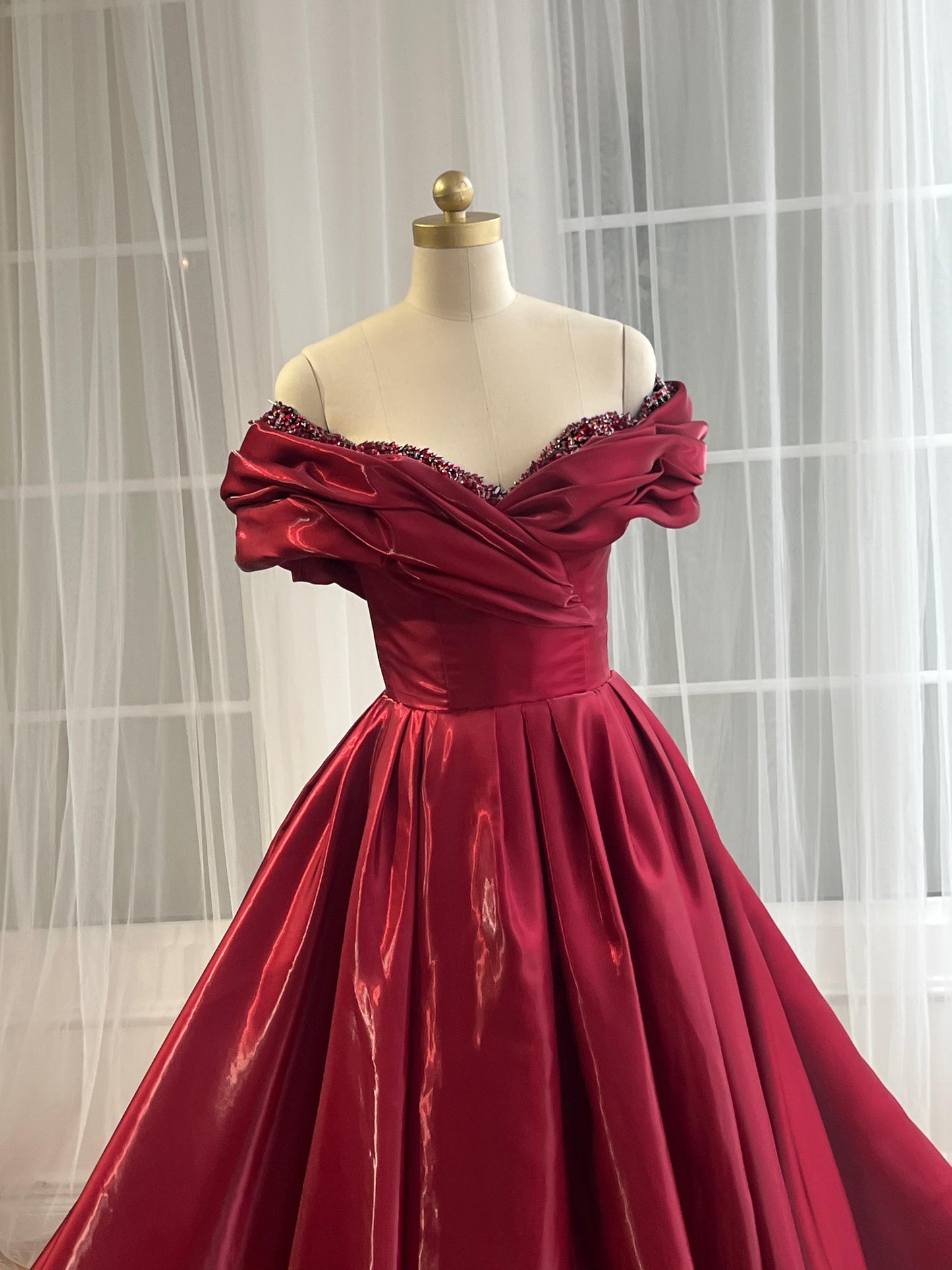 Red A-Line gown with off the shoulder sleeves and embroidery