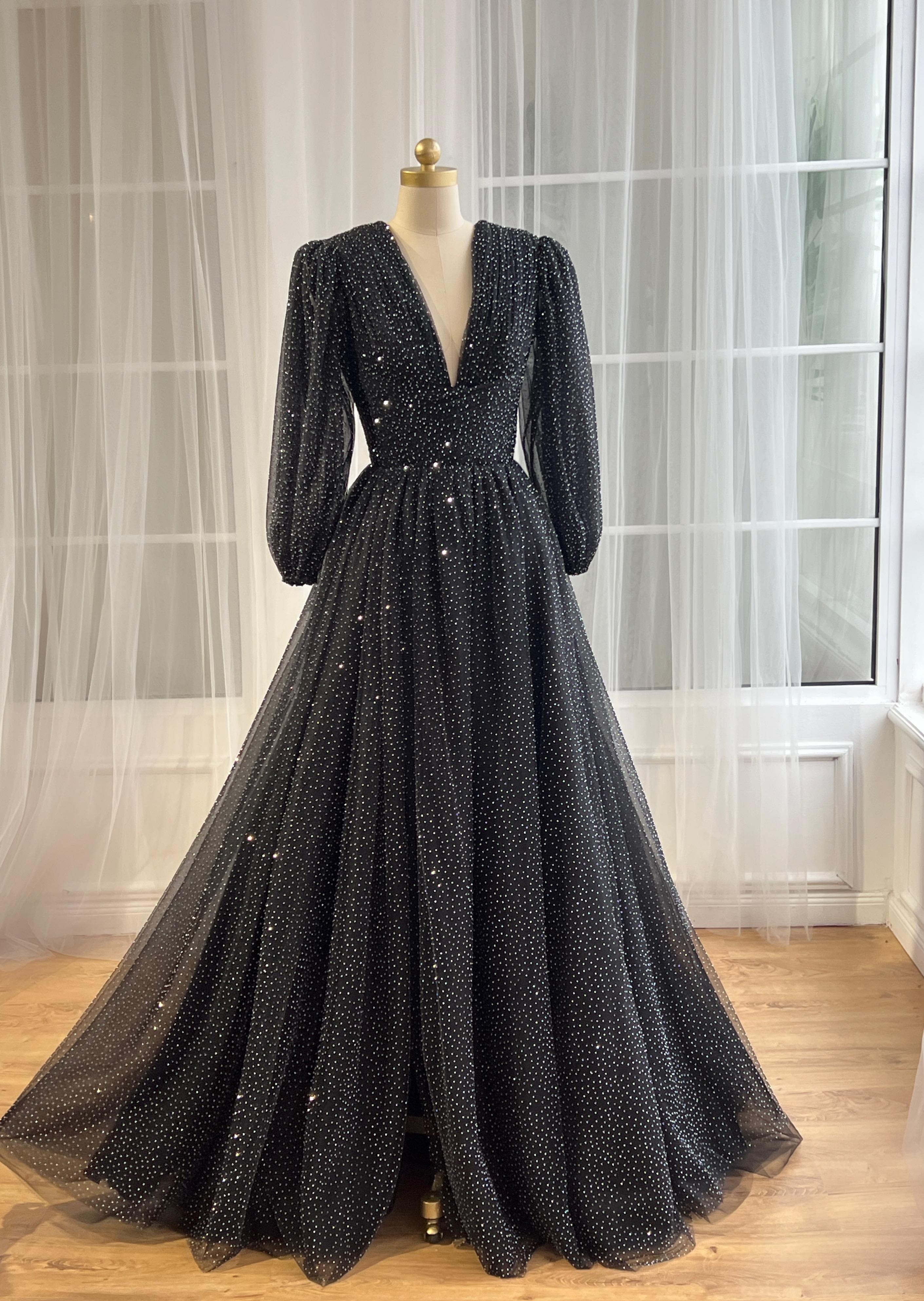 Black beaded A-Line gown with v-neck and long sleeves