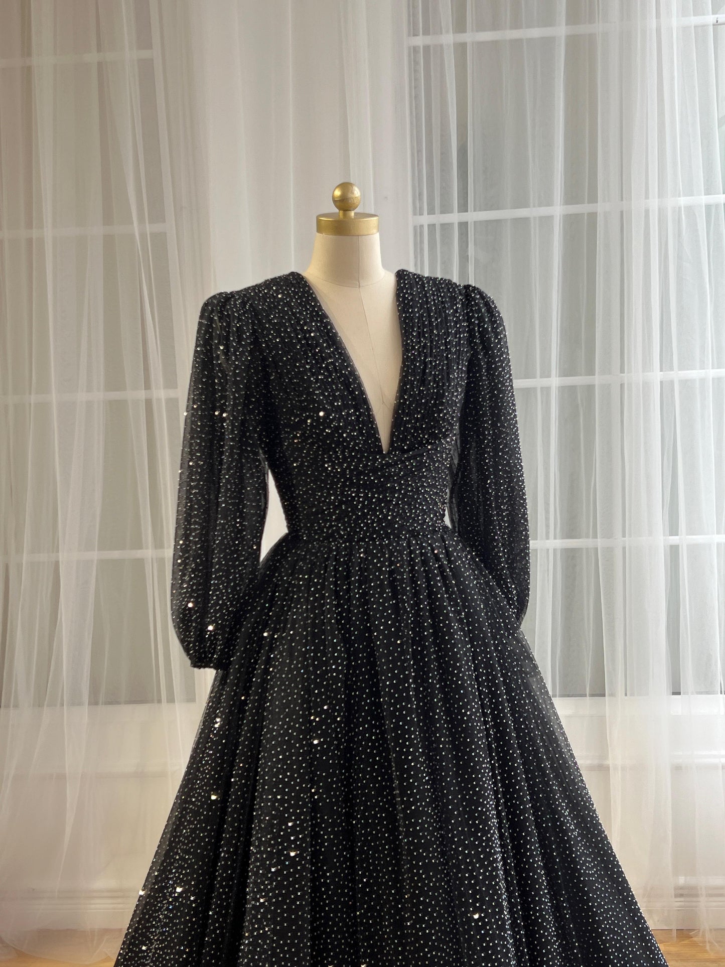 Black beaded A-Line gown with v-neck and long sleeves