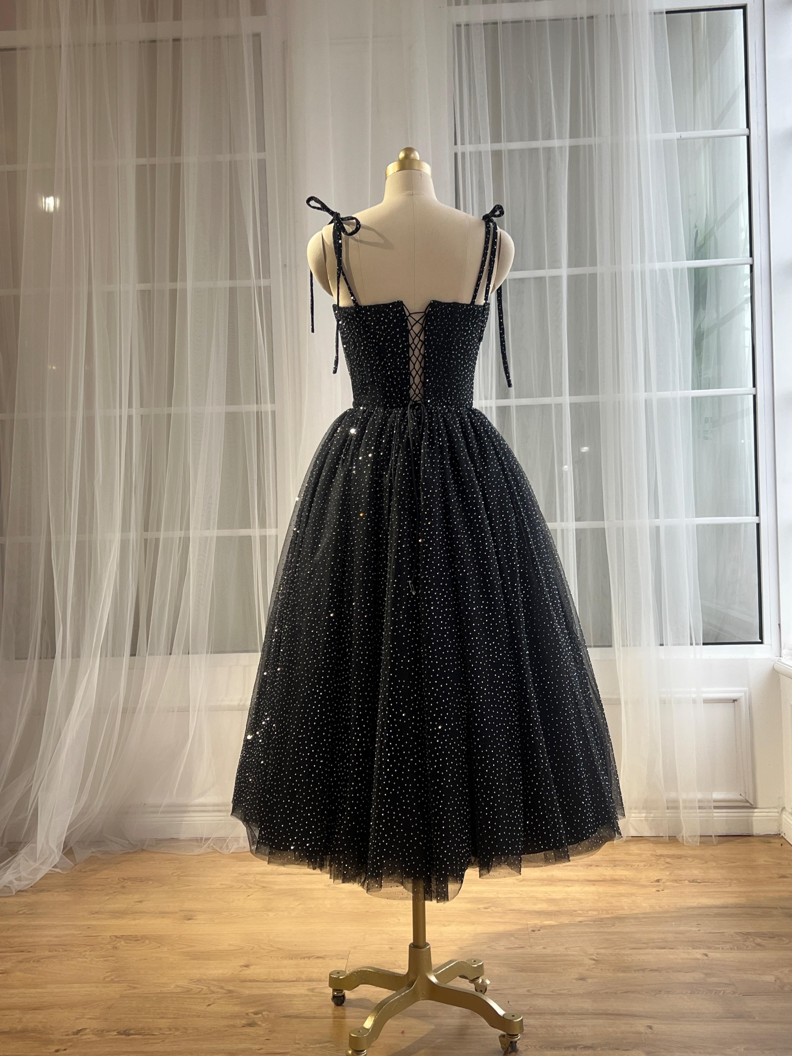Black midi dress with spaghetti straps and beading fabric