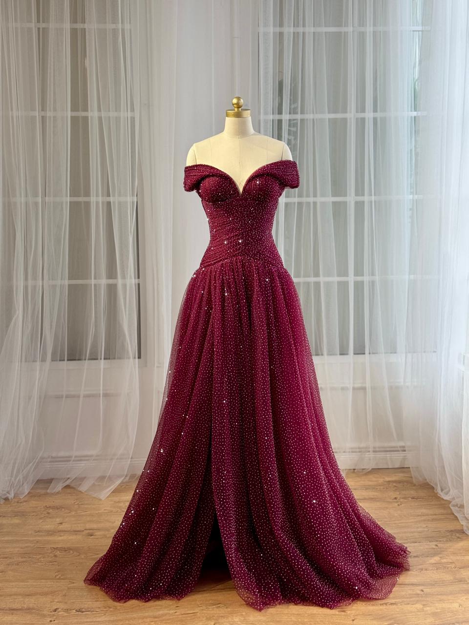 Red A-Line gown with off the shoulder sleeves and beading