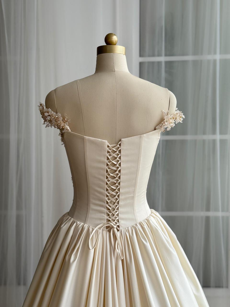 Beige A-Line gown with off the shoulder sleeves and embroidery