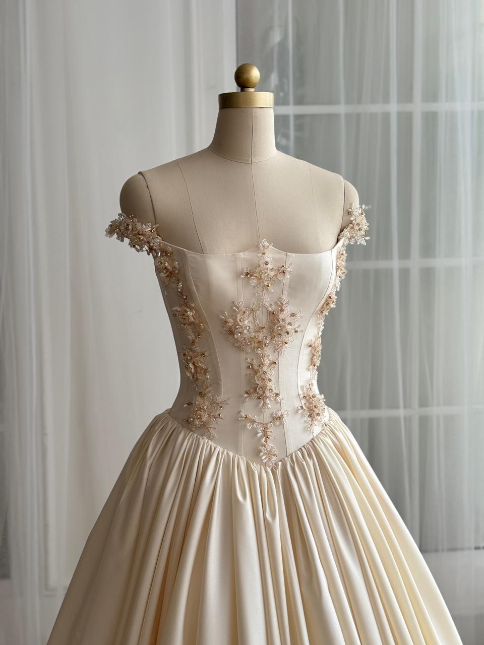 Beige A-Line gown with off the shoulder sleeves and embroidery