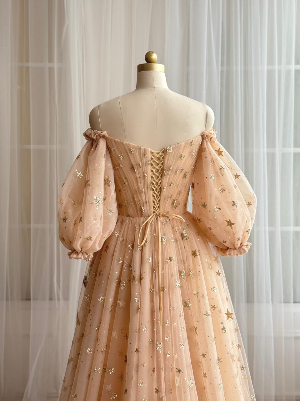 Gold A-Line dress with long off the shoulder sleeves, v-neck and starry tulle fabric
