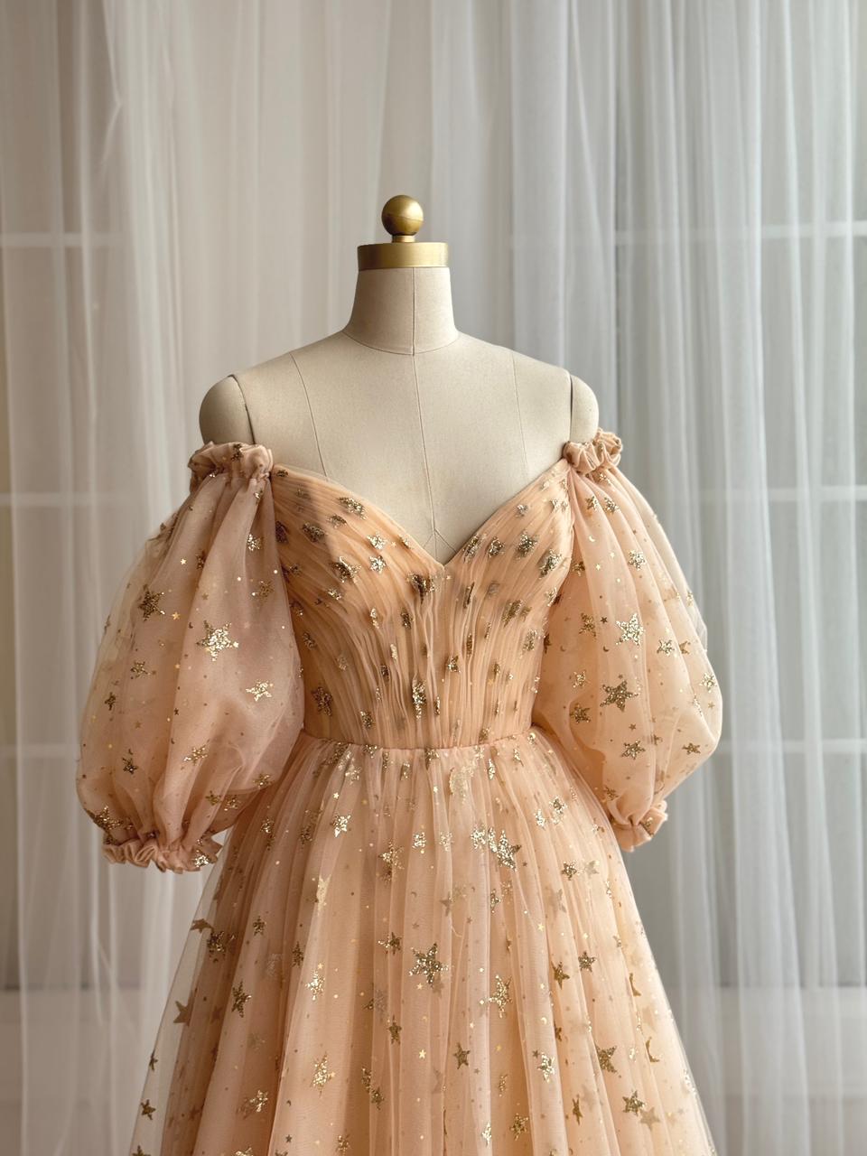 Gold A-Line dress with long off the shoulder sleeves, v-neck and starry tulle fabric