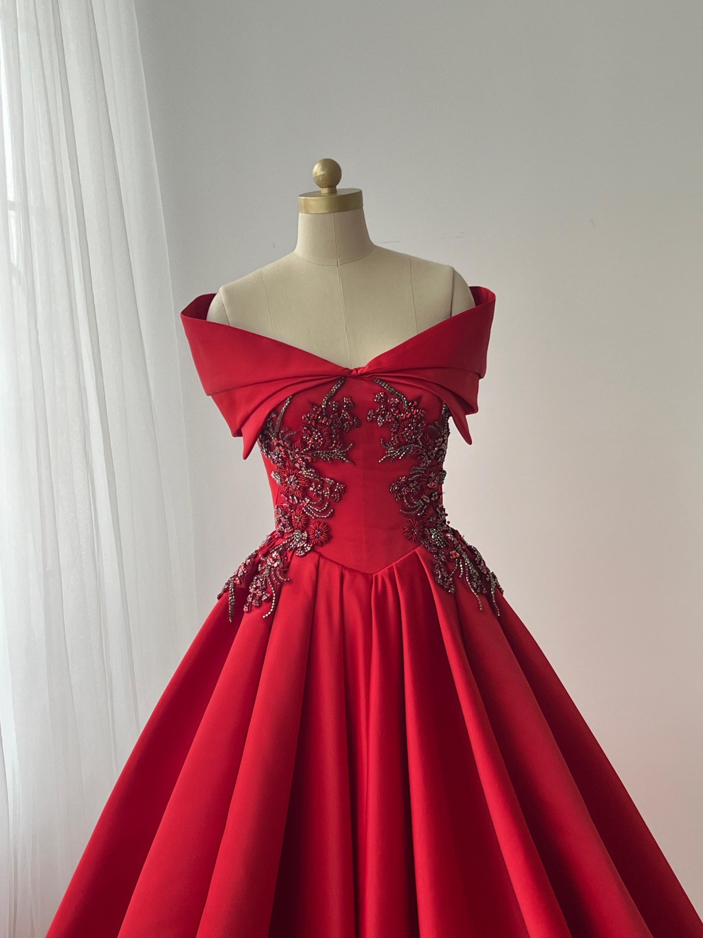 Red A-Line gown with off the shoulder sleeves and embroidery