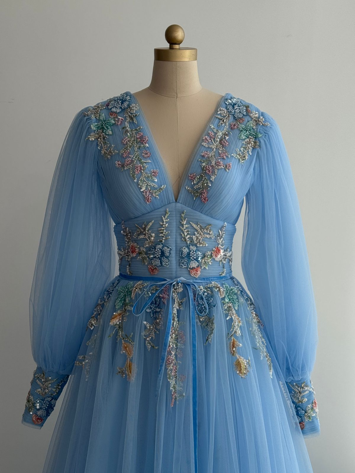 Blue A-Line gown with long sleeves, v-neck and embroidery