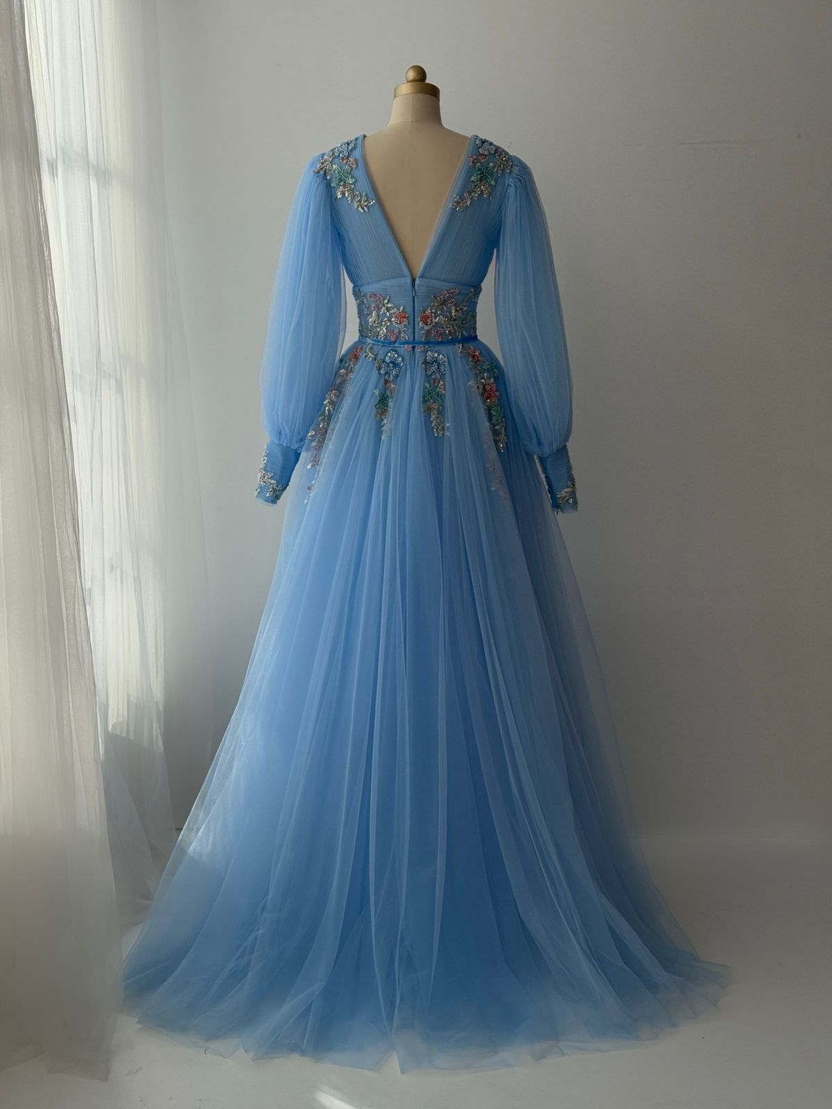 Blue A-Line gown with long sleeves, v-neck and embroidery
