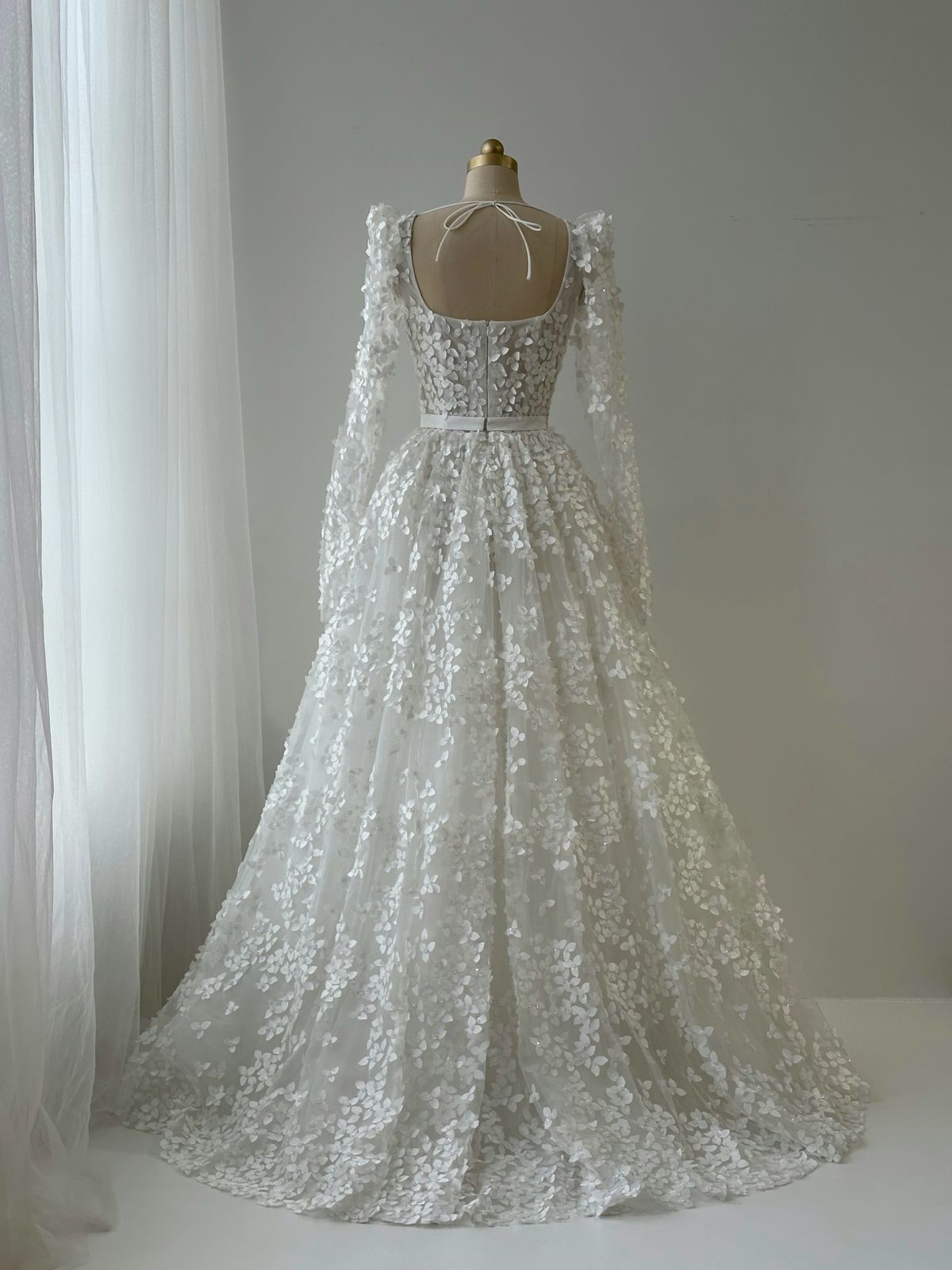 White bridal A-Line gown with long sleeves, bow and embroidery