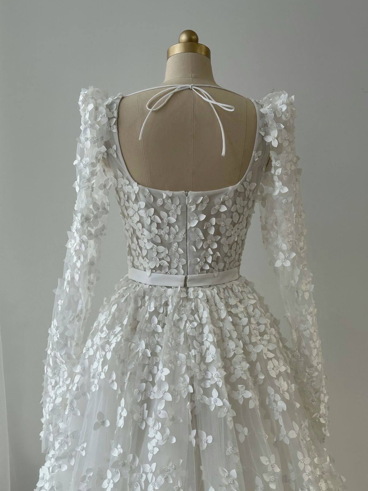 White bridal A-Line gown with long sleeves, bow and embroidery