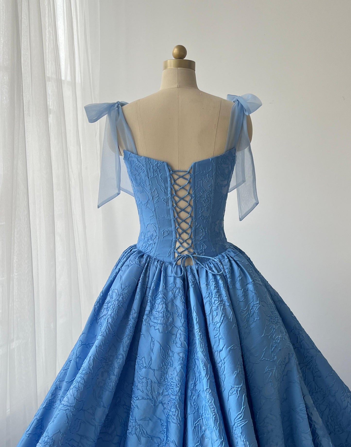 Blue A-Line gown with bow straps and brocade fabric