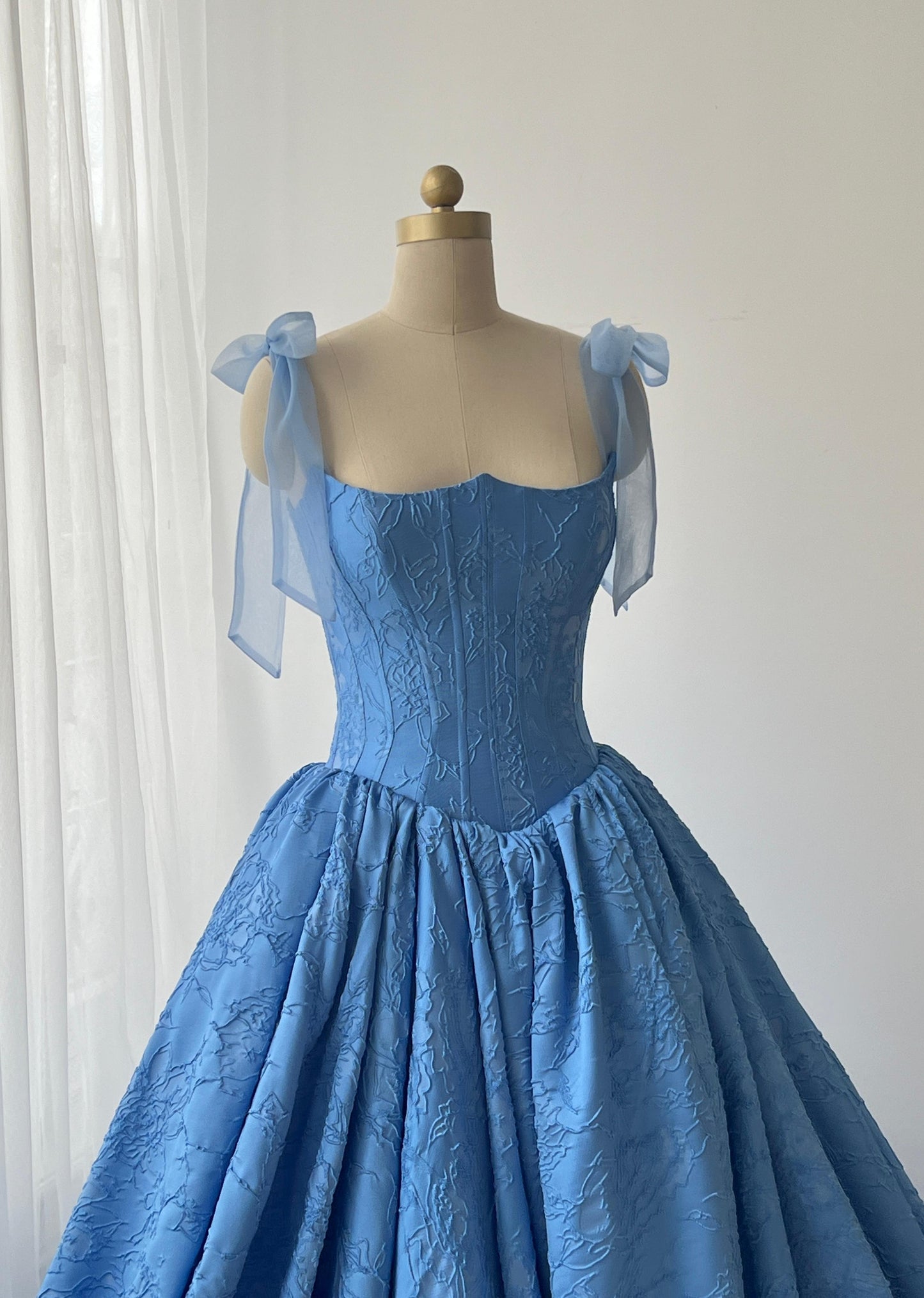 Blue A-Line gown with bow straps and brocade fabric