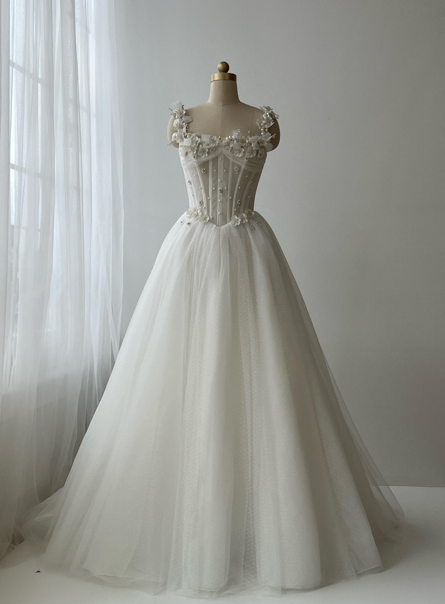 White bridal A-Line gown with straps, embroidery and pearls