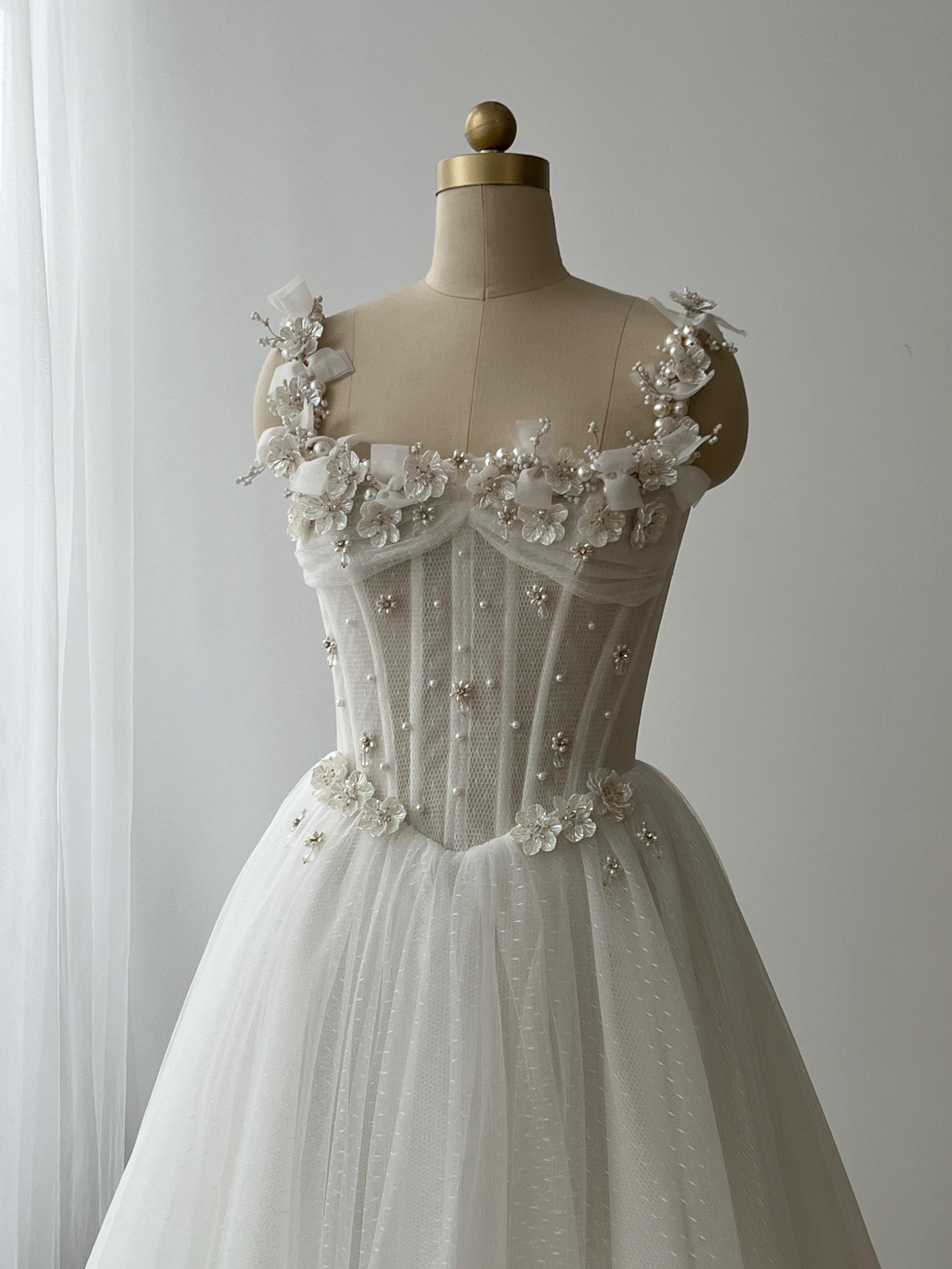 White bridal A-Line gown with straps, embroidery and pearls