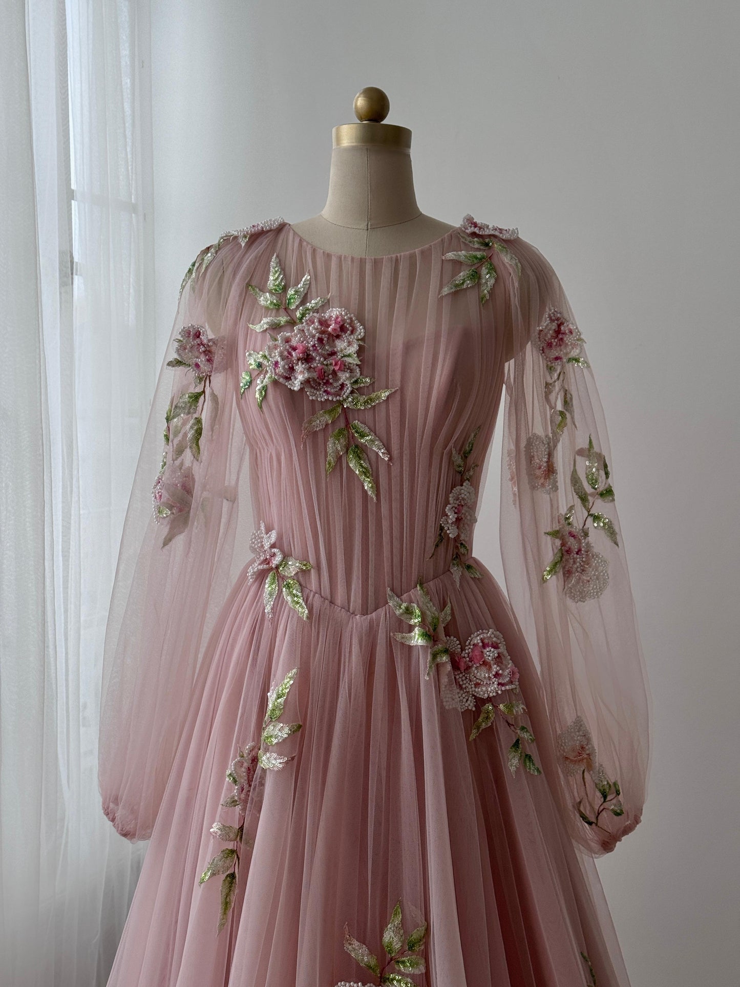 Pink A-Line gown with long sleeves, tulle fabric and embroidered flowers