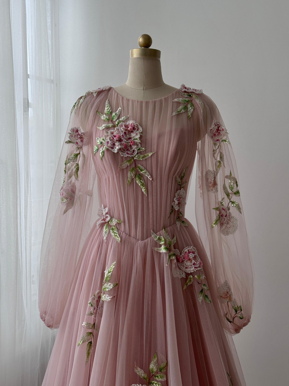 Pink A-Line gown with long sleeves, tulle fabric and embroidered flowers