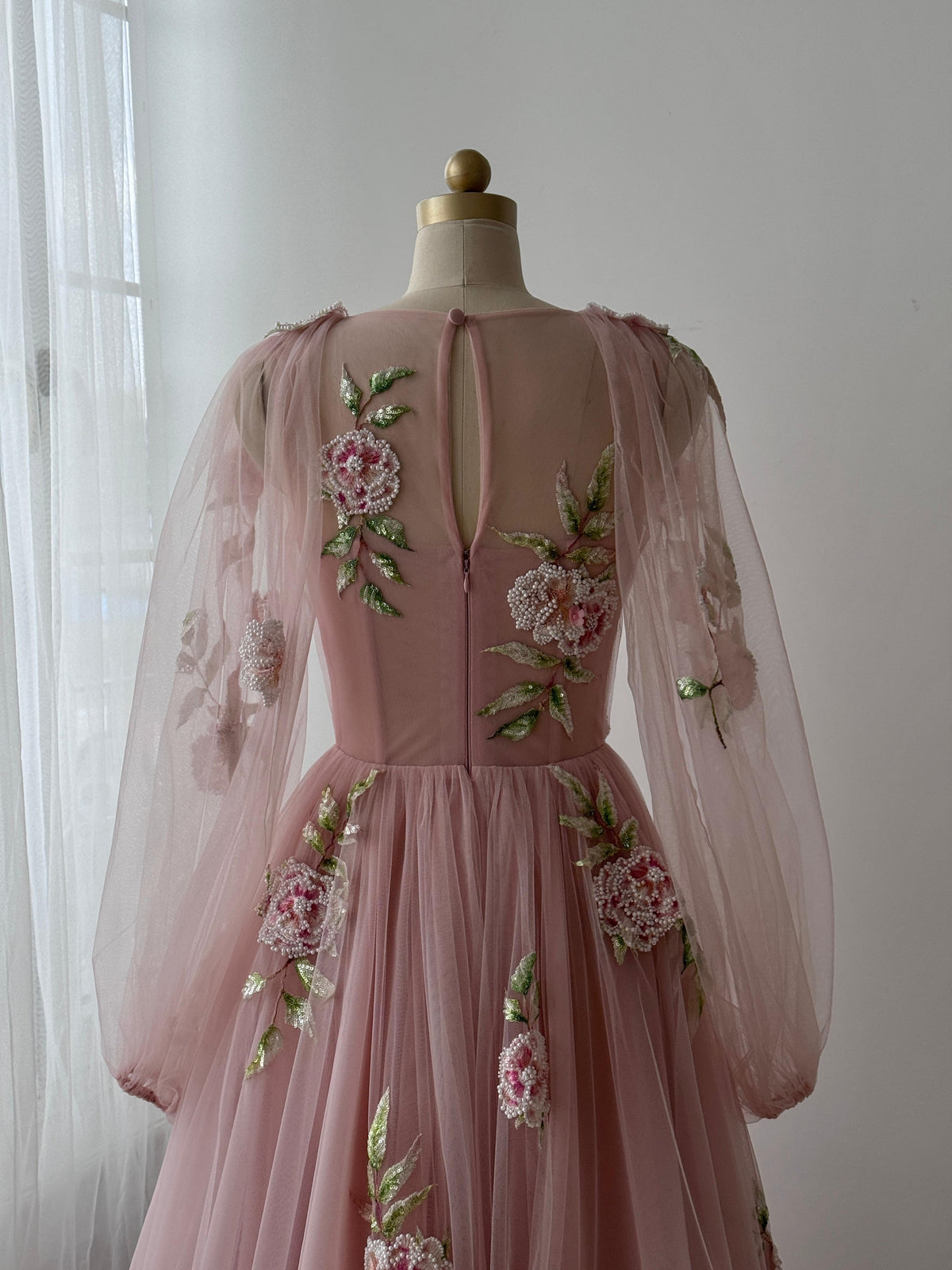 Pink A-Line gown with long sleeves, tulle fabric and embroidered flowers