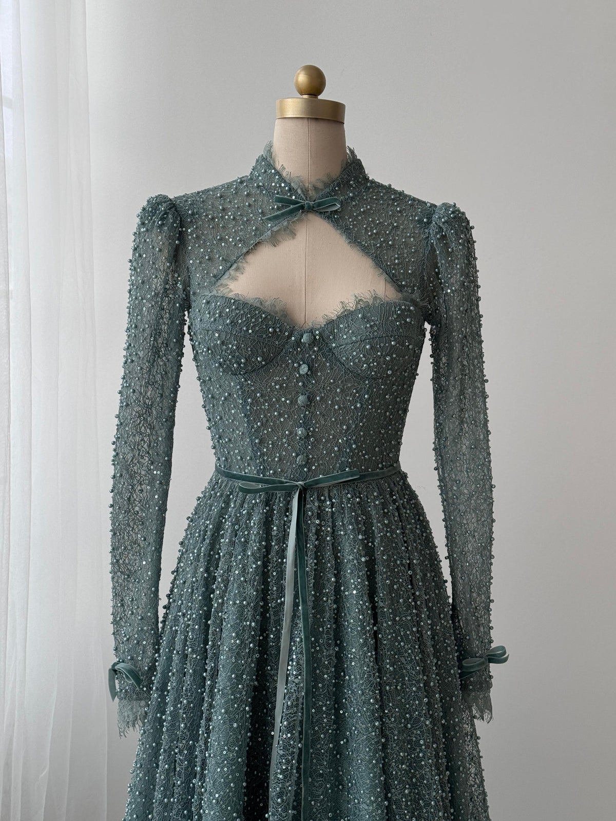 Turquoise A-Line gown with long sleeve, bolero, beading and embroidered bows