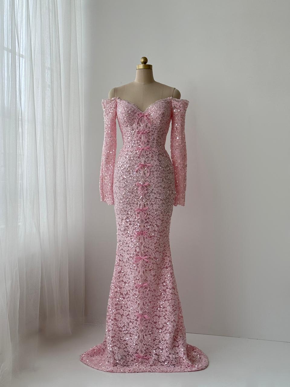 Pink mermaid gown with long off the shoulder sleeves, embroidered bows and lace