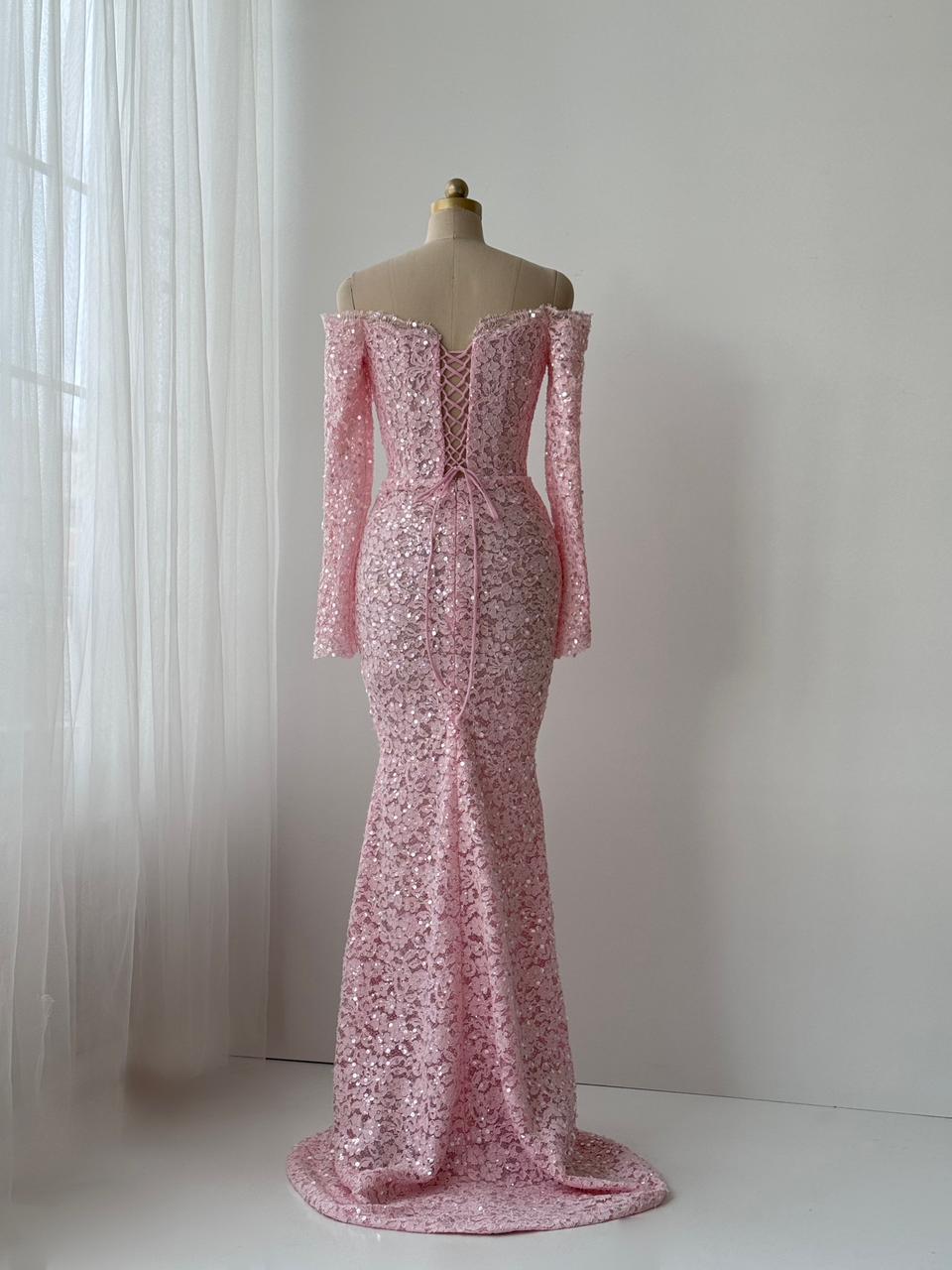 Pink mermaid gown with long off the shoulder sleeves, embroidered bows and lace