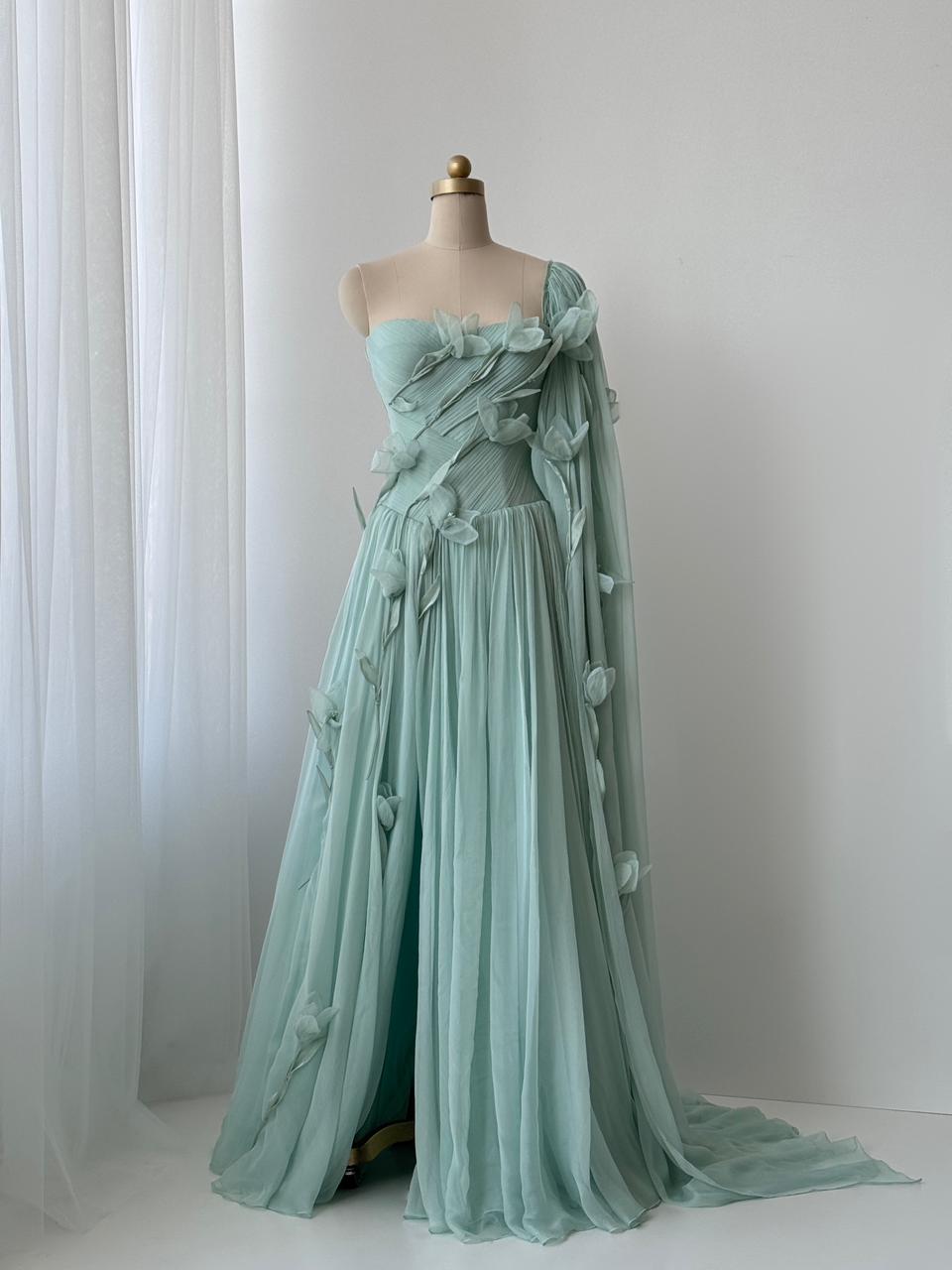 Turquoise A-Line gown with embroidered petals and one shoulder cape sleeve
