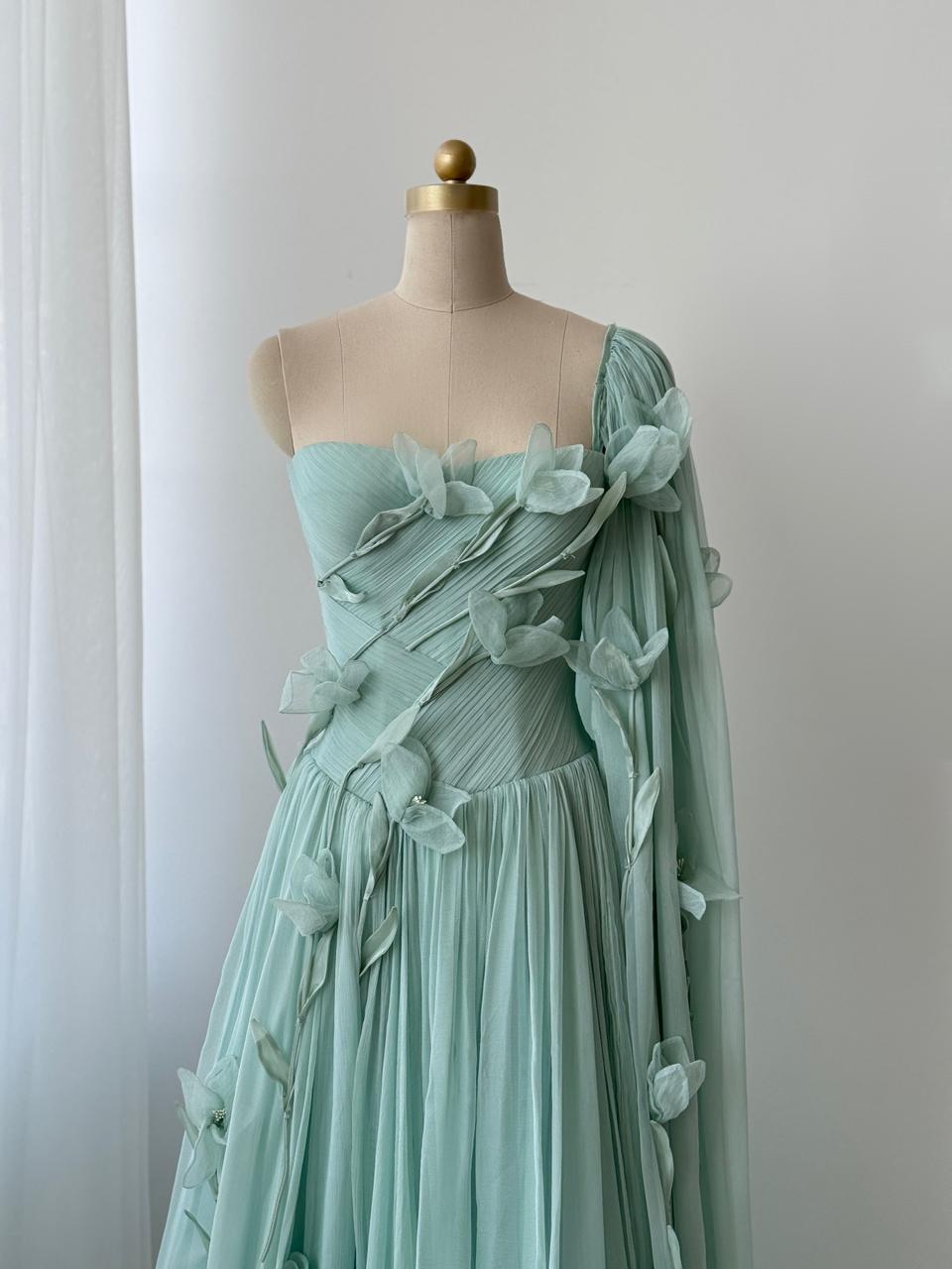 Turquoise A-Line gown with embroidered petals and one shoulder cape sleeve