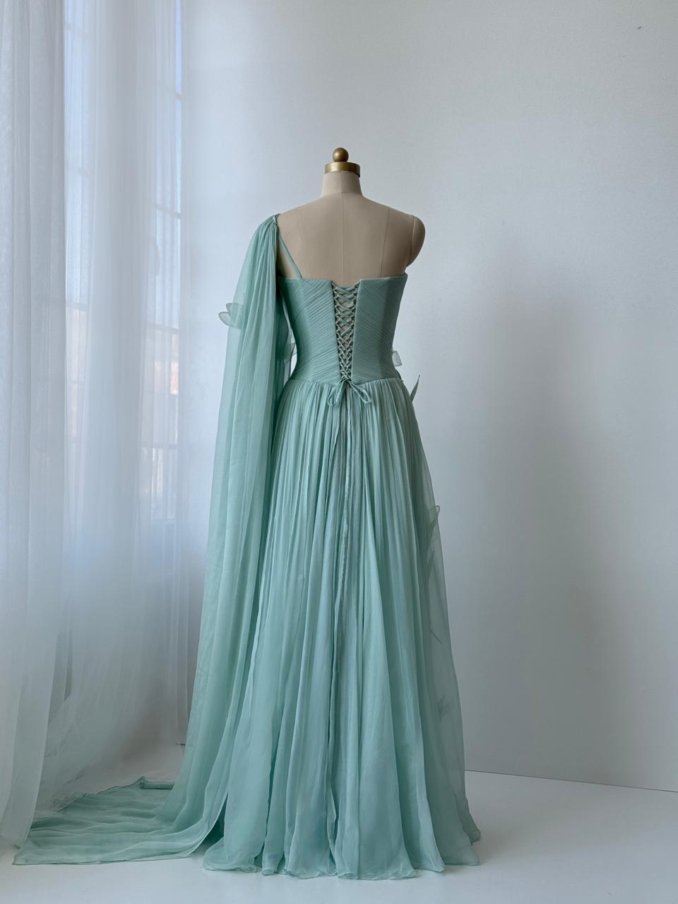 Turquoise A-Line gown with embroidered petals and one shoulder cape sleeve