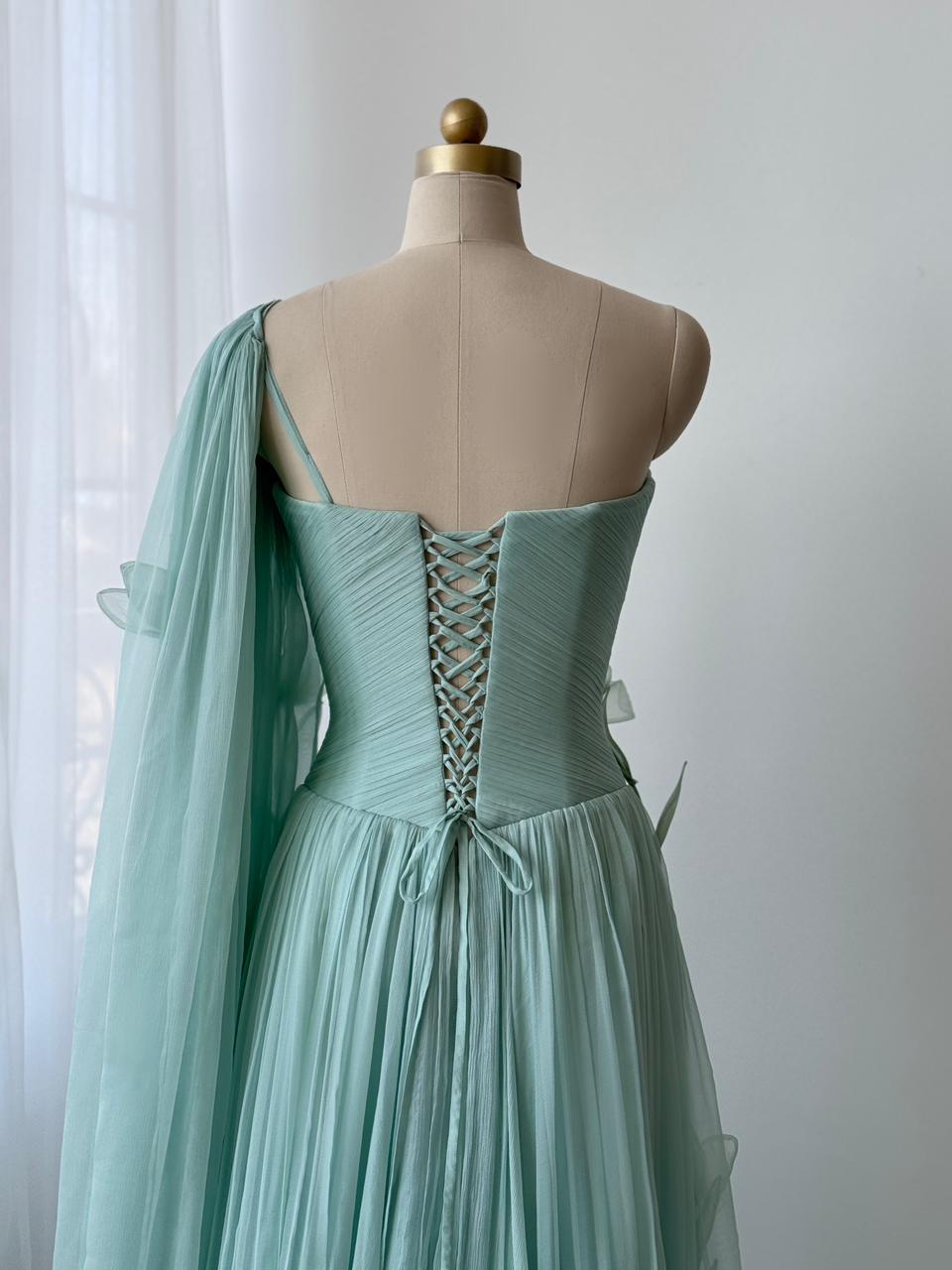 Turquoise A-Line gown with embroidered petals and one shoulder cape sleeve