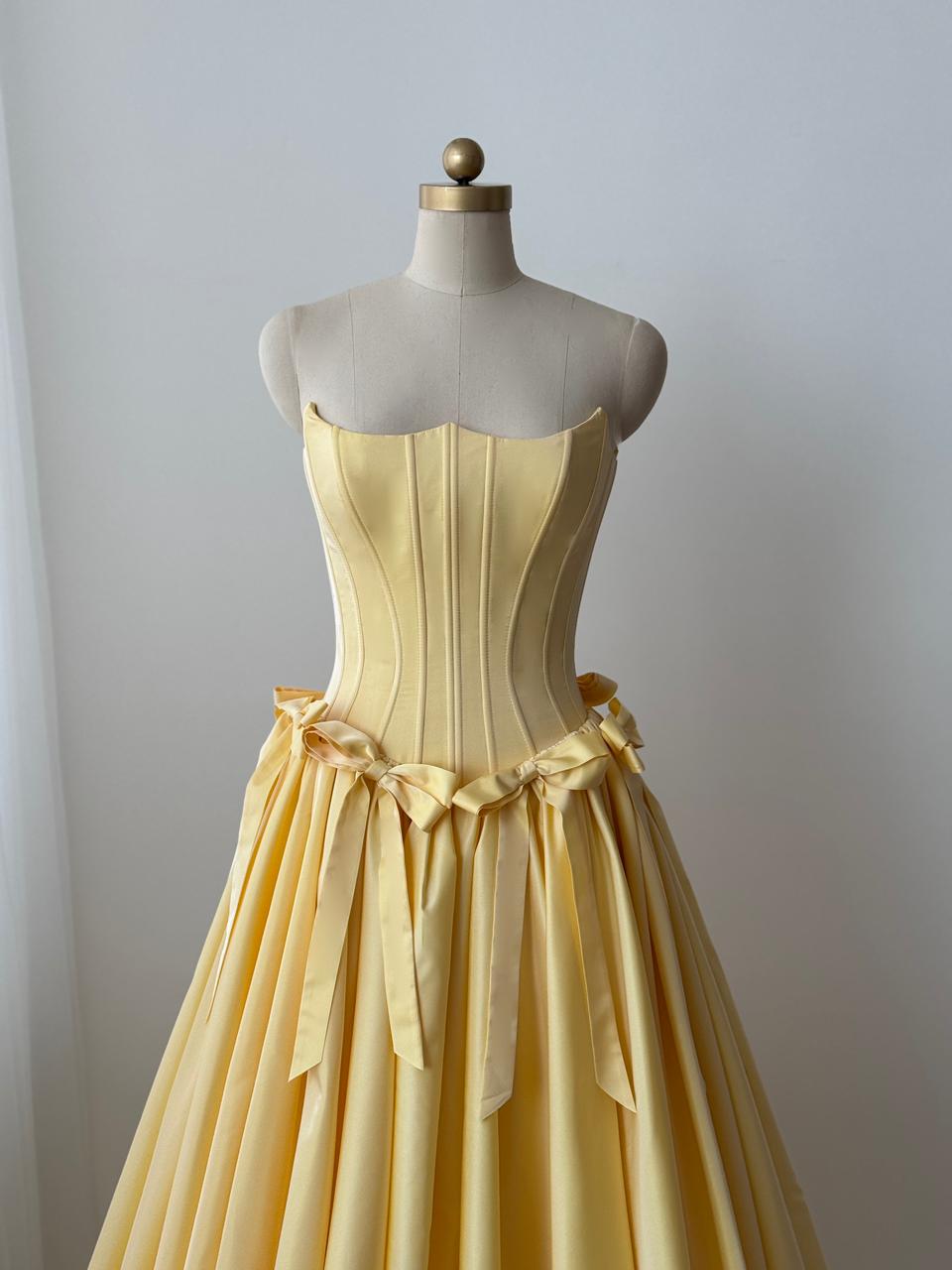 Yellow A-Line gown with embroidered bows and no sleeves