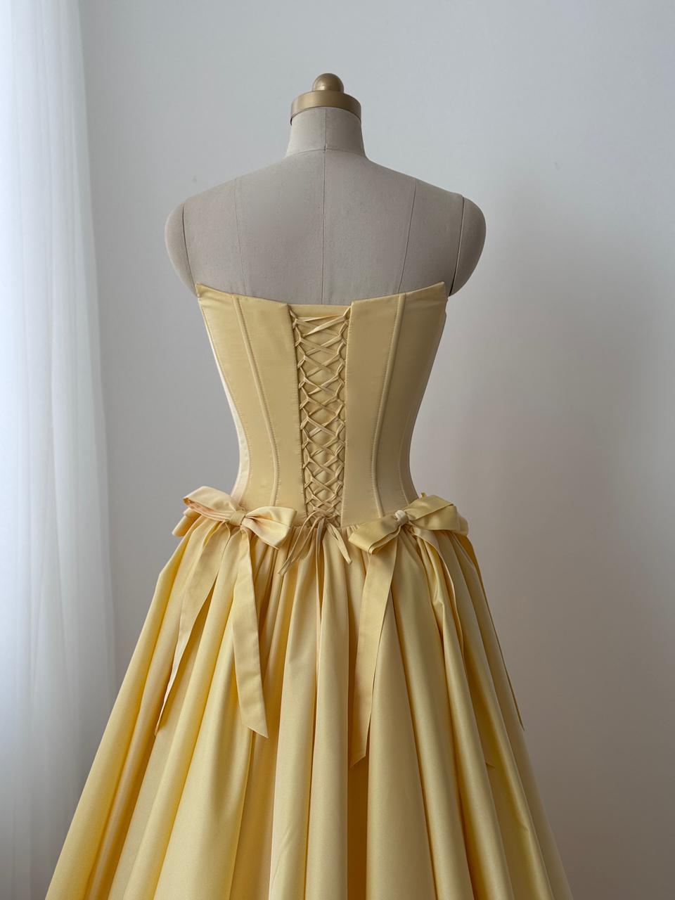 Yellow A-Line gown with embroidered bows and no sleeves