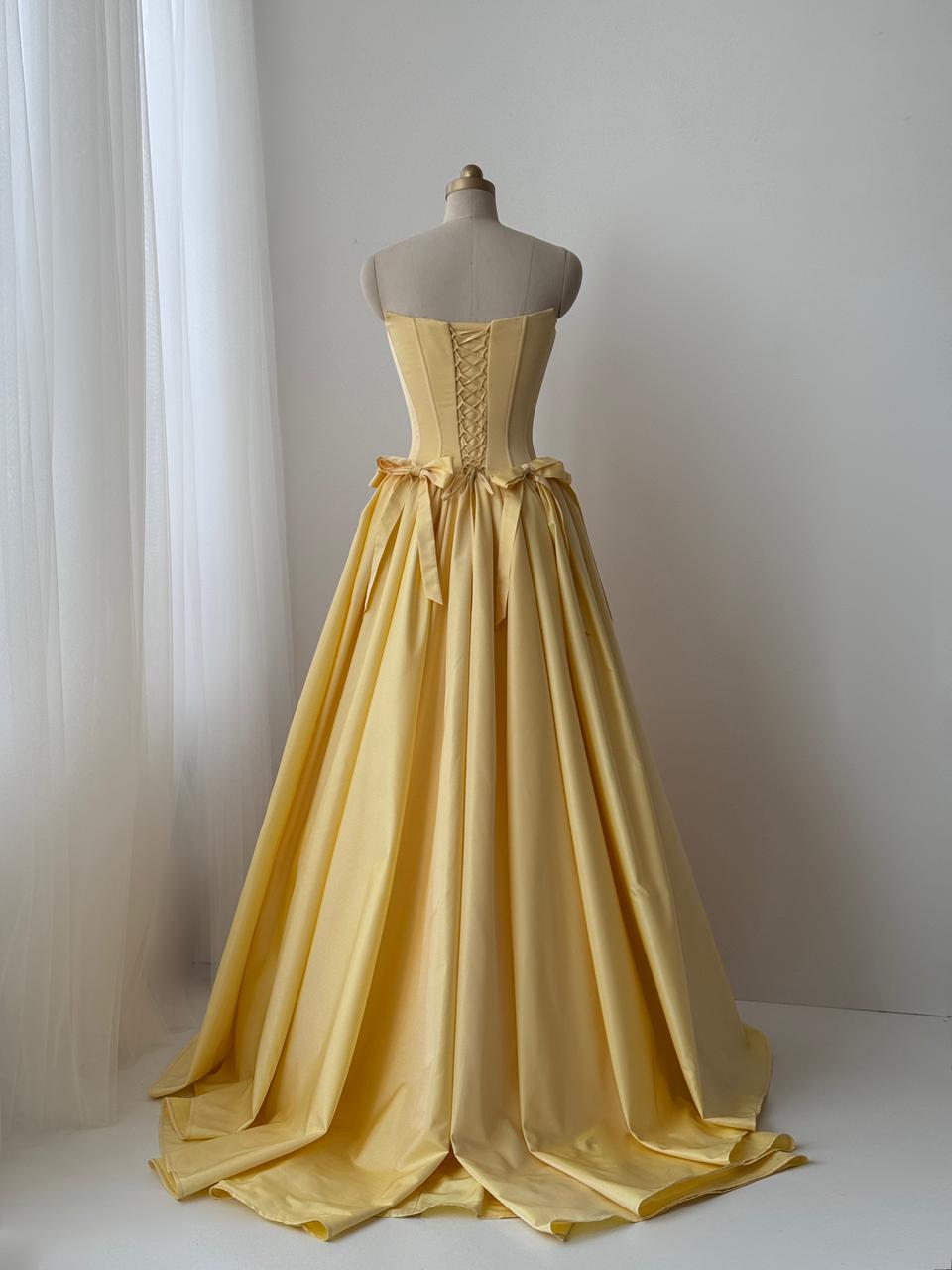 Yellow A-Line gown with embroidered bows and no sleeves