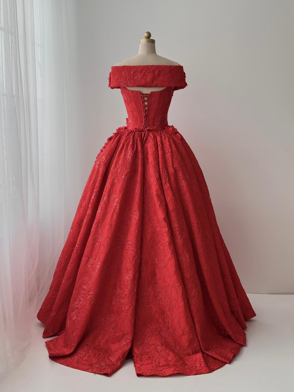 Red A-line gown with overskirt, off the shoulder sleeves and embroidery