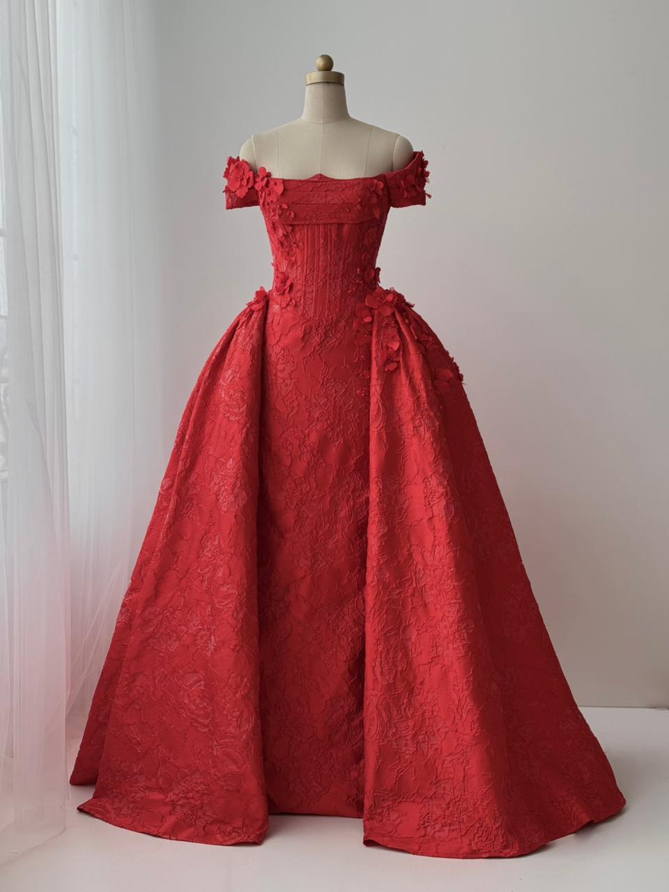 Red A-line gown with overskirt, off the shoulder sleeves and embroidery