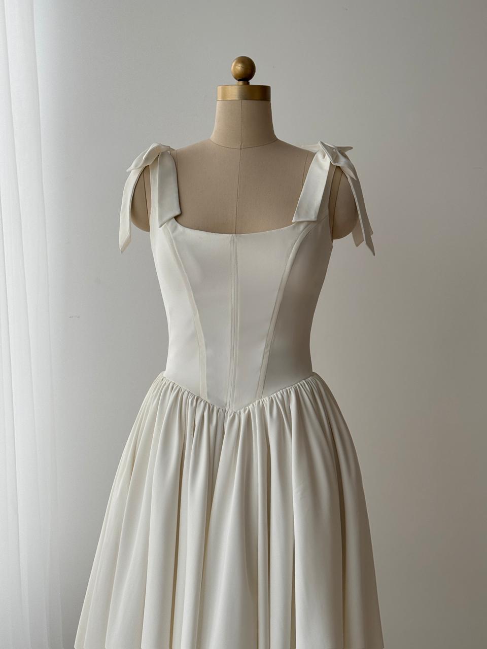 White bridal midi dress with bow straps and taffeta fabric