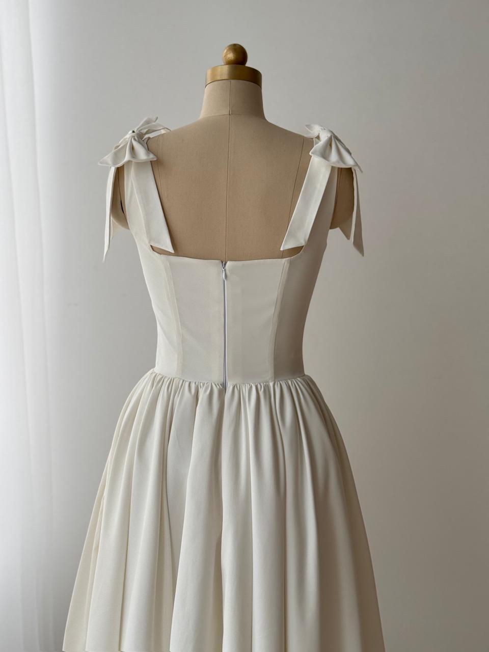 White bridal midi dress with bow straps and taffeta fabric