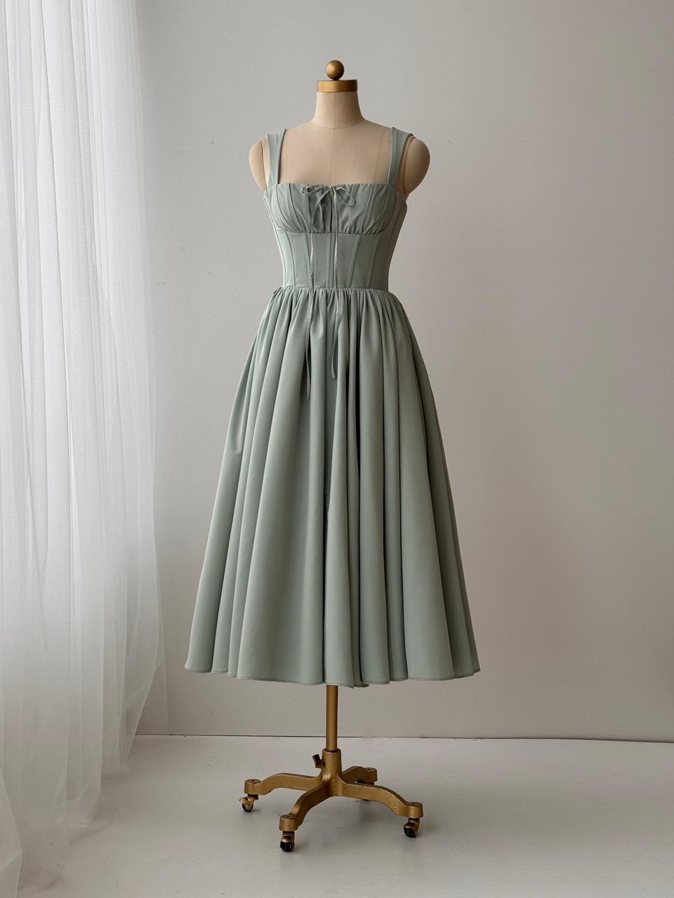 Green midi dress with embroidered bow and straps