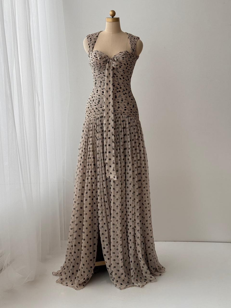 Beige gown with straps, polka dotted tulle fabric and embroidered front bow