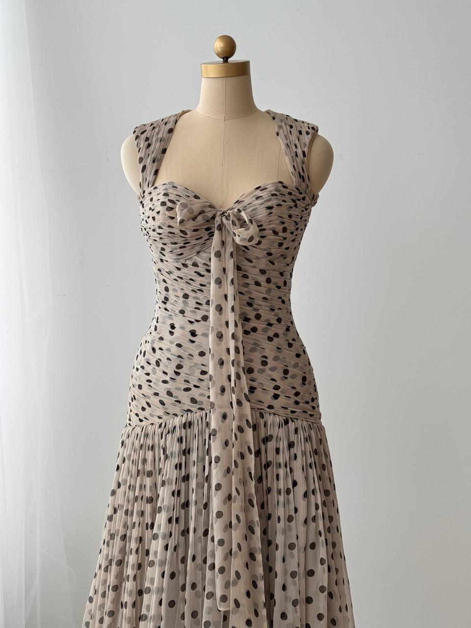 Beige gown with straps, polka dotted tulle fabric and embroidered front bow