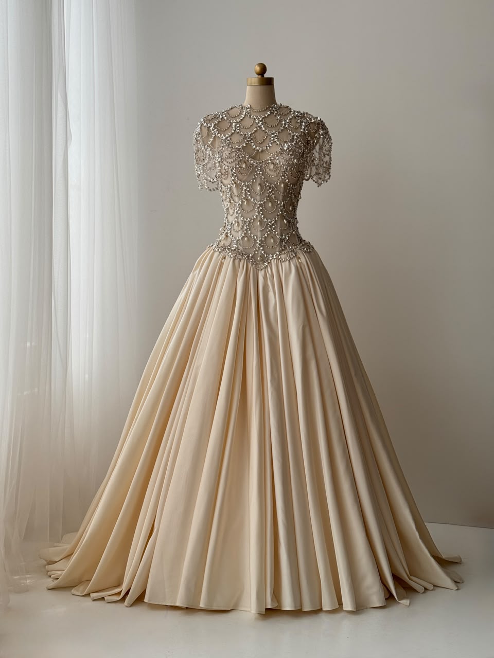 Beige A-Line bridal gown, with short sleeves, beading work and embroidery