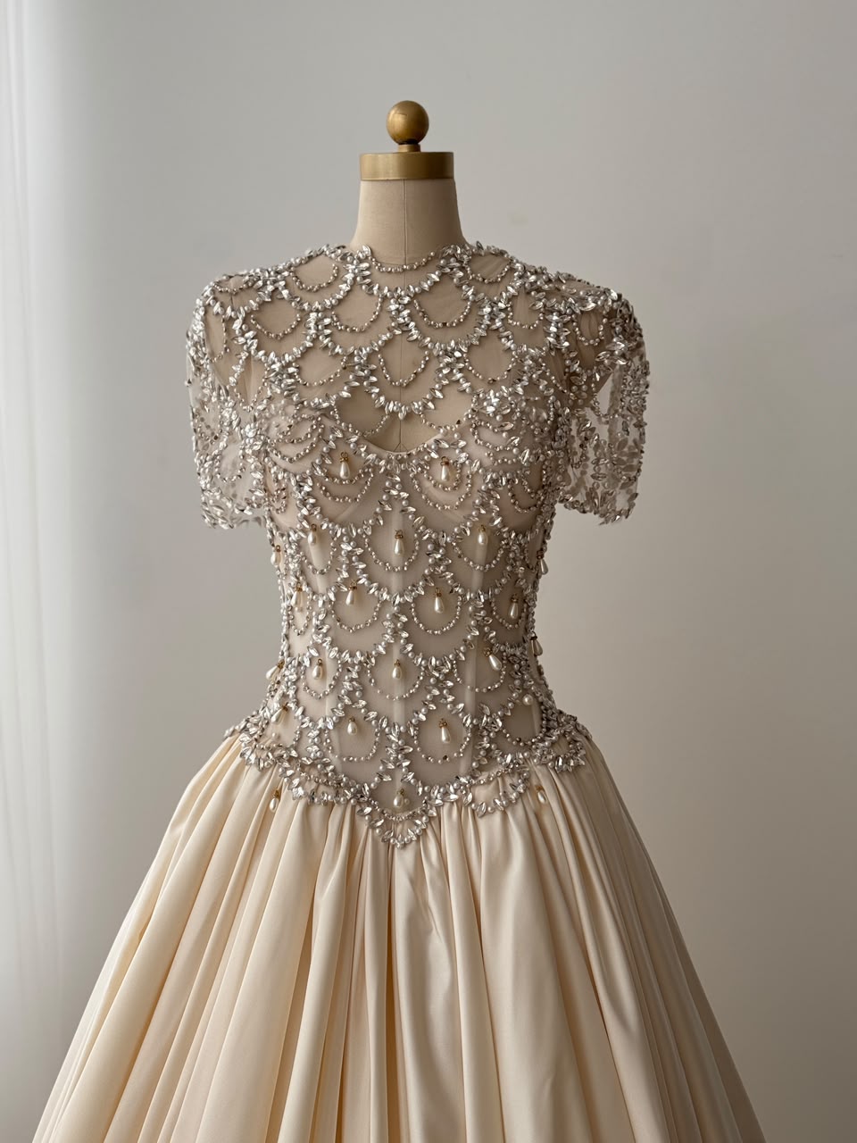 Beige A-Line bridal gown, with short sleeves, beading work and embroidery