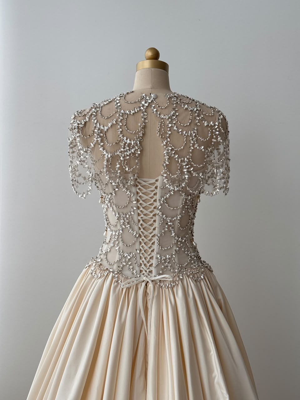 Beige A-Line bridal gown, with short sleeves, beading work and embroidery
