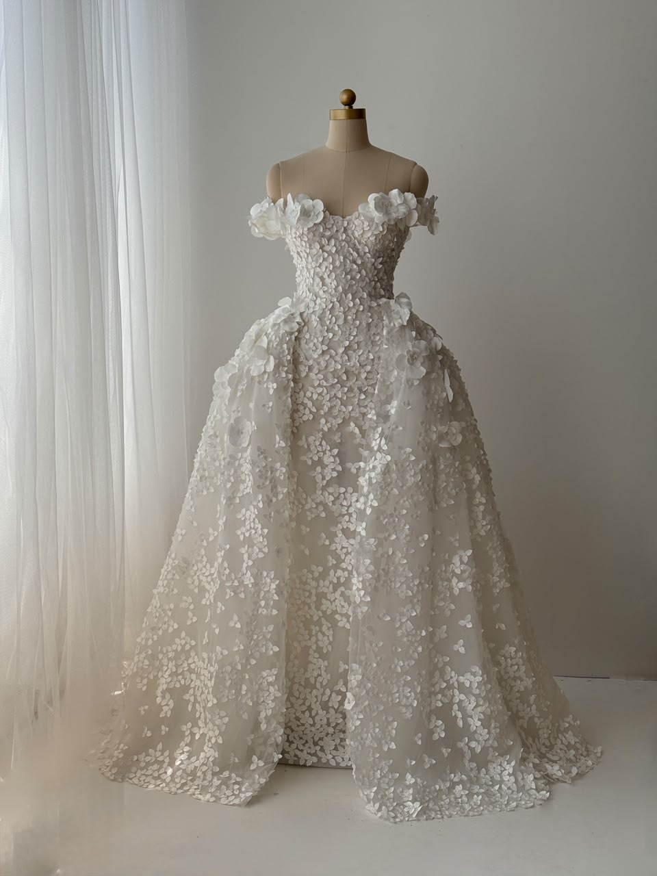 White A-Line bridal gown with off the shoulder sleeves, embroidery and detachable skirt