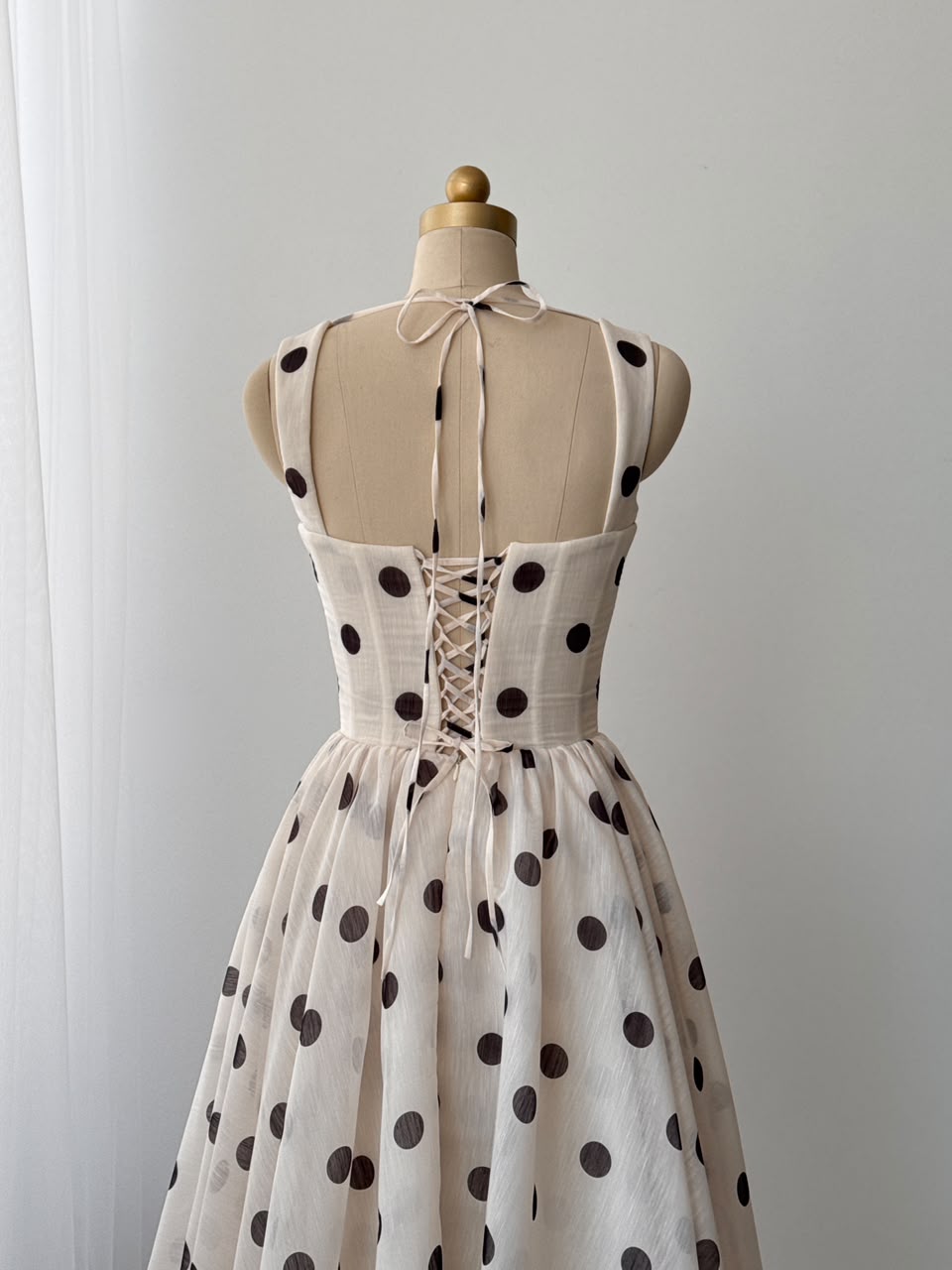 Beige midi dress with polka dotted fabric and straps