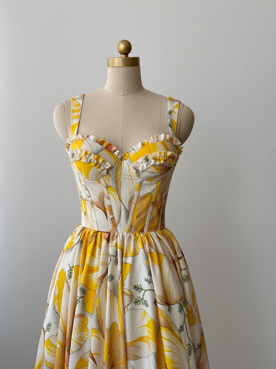 Yellow midi dress with printed floral fabric, straps and embroidered work