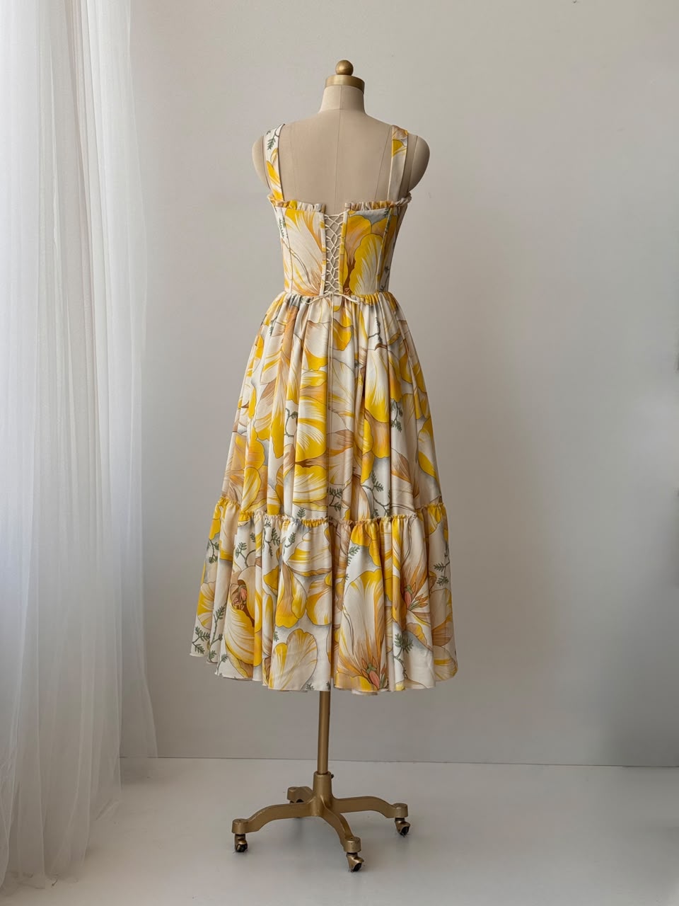 Yellow midi dress with printed floral fabric, straps and embroidered work