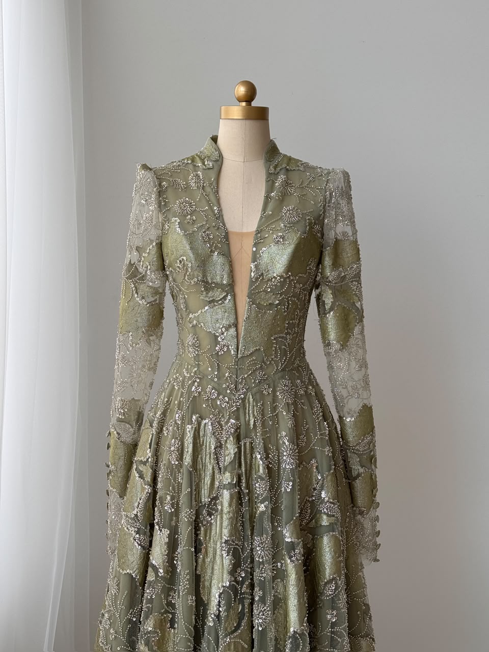 Green A-Line gown with long sleeves, sequins and v-neck