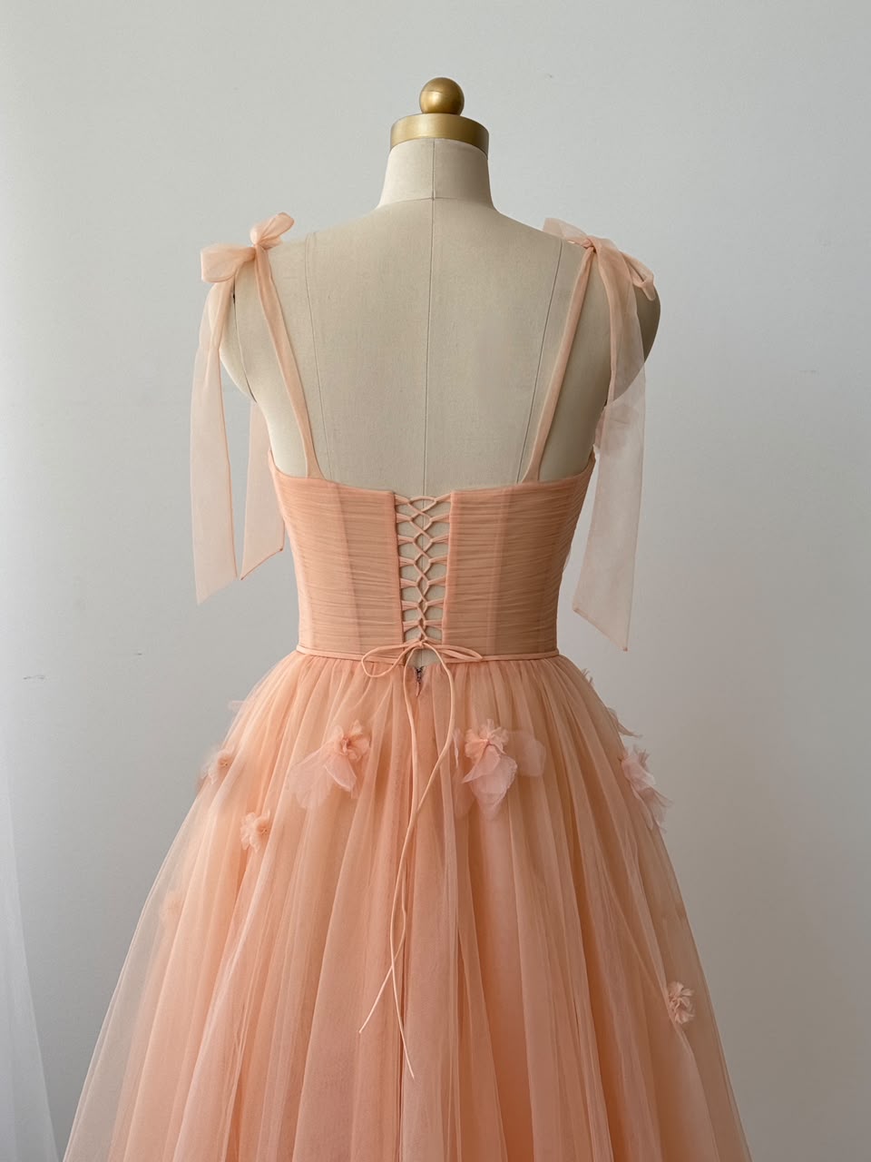 Peach midi dress with bow straps and embroidered flowers